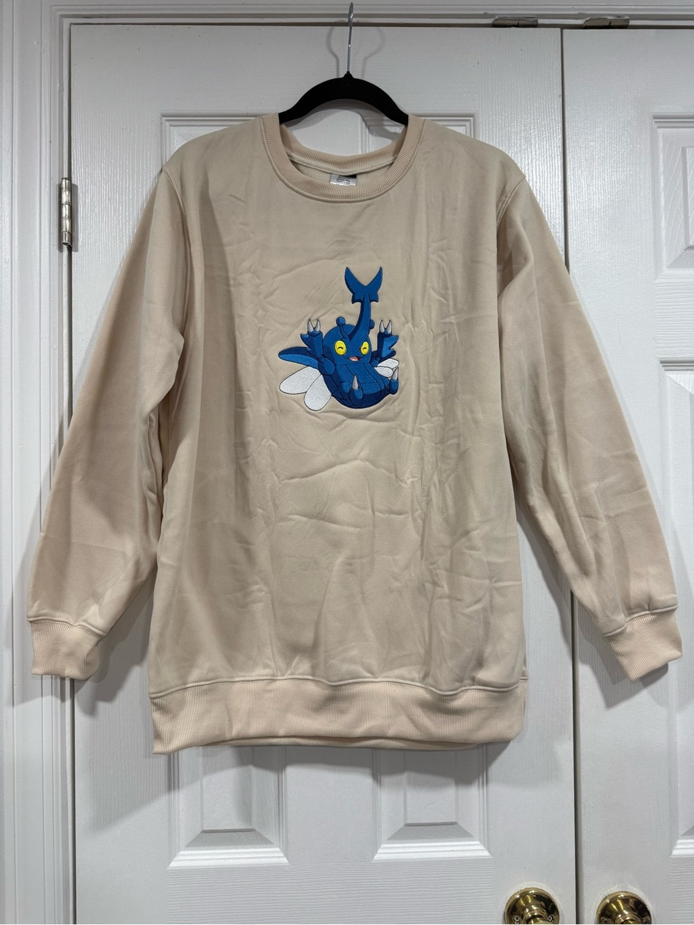 Cream Crewneck Sweater with Blue Cartoon Motif